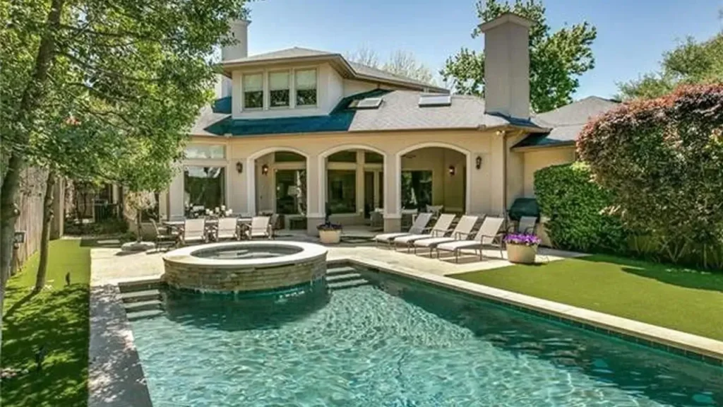 Luxury backyard with resort-style swimming pool and covered patio at the Naples house plan.